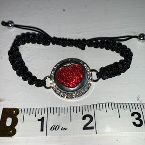 Adjustable braided black cord bracelet with one interchangeable snaps.NWOT